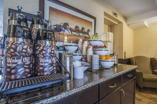 a kitchen with a counter with food on it at Comfort Inn & Suites Edson in Edson