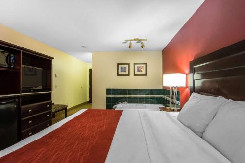 a large bedroom with a large bed and a television at Comfort Inn & Suites Airport South in Calgary