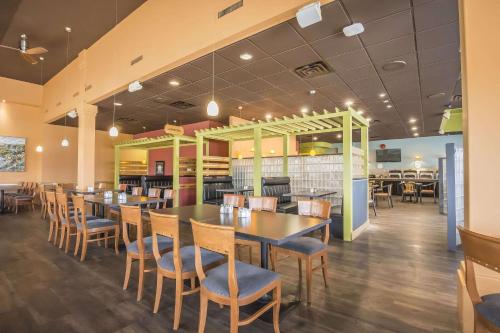 a dining room with tables and chairs in a restaurant at Quality Inn West Edmonton in Edmonton