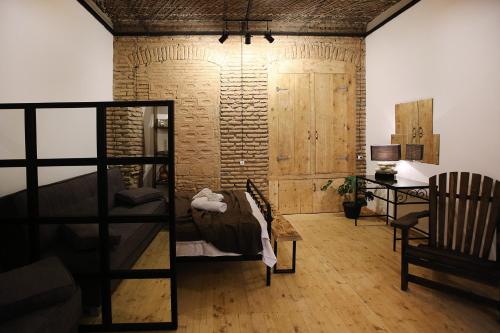 a living room with a couch and a chair and a table at Chrono Room in Tbilisi City