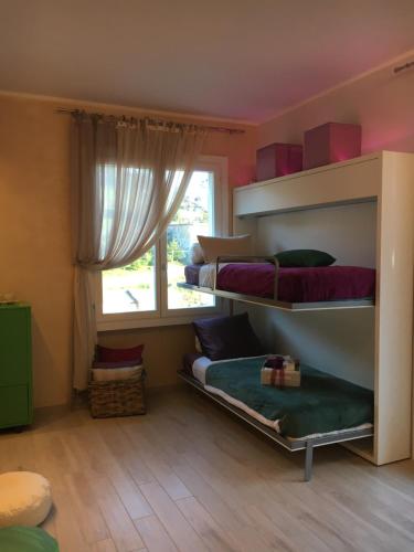 a bedroom with two bunk beds and a window at BougainvilleaP in Monterosso al Mare