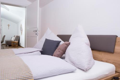 a bedroom with a bed with pillows on it at Oberschartlhof in Flachau