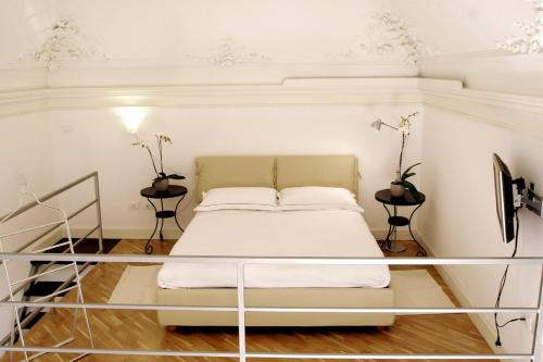 a bedroom with a bed and two side tables at Ognina Residence in Catania