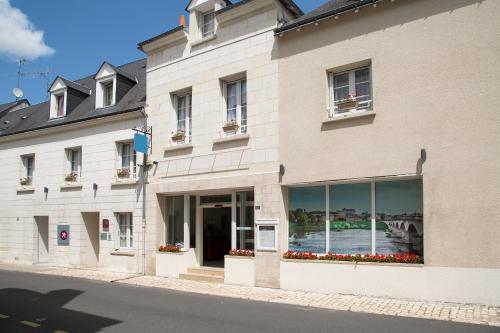 a building with flowers in the windows of a building at Logis Hôtel Restaurant Chaptal, Amboise in Amboise