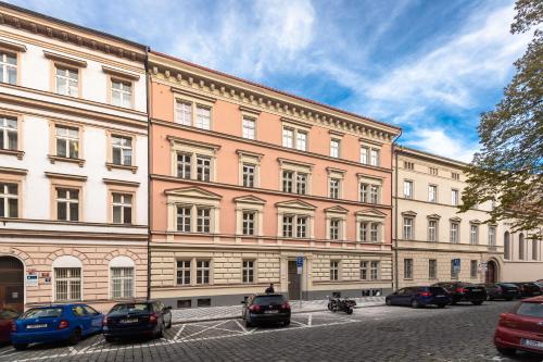 a large building with cars parked in front of it at Seven Wishes Boutique Residence in Prague