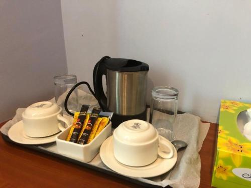 a tray with two cups and chopsticks on a table at Green Mountain Hotel in Arusha
