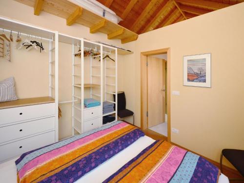 a bedroom with a bed and a white closet at Finca La Bonita in Puntagorda