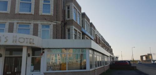 a tall brick building with a sign on it at Hotel Avano - Pleasure Beach in Blackpool