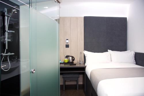 a hotel room with a bed and a shower at The Z Hotel Bath in Bath