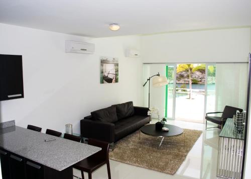 a living room with a couch and a table at Piscadera Harbour Village in Willemstad