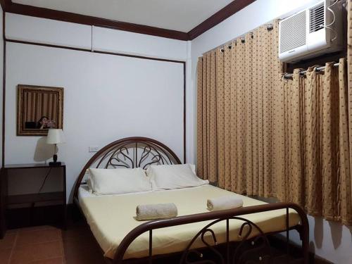 a bedroom with a bed with a large window at Casa Tentay in Iloilo City