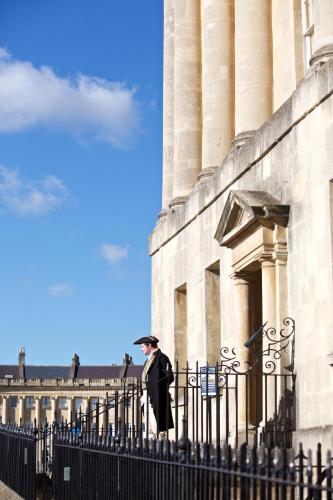 a man with an umbrella standing next to a building at The Z Hotel Bath in Bath