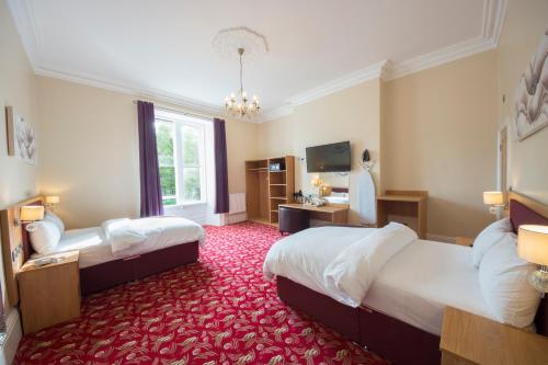 Katil atau katil-katil dalam bilik di Edgerton Hotel