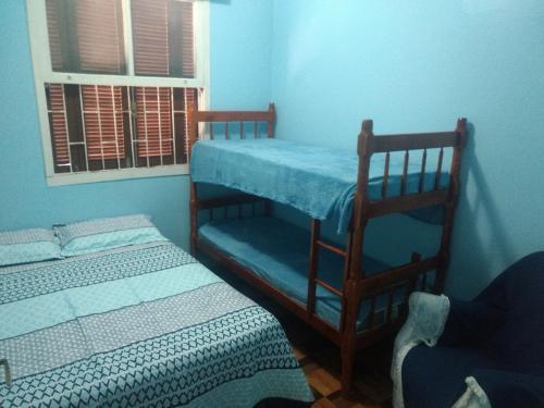 a bedroom with two bunk beds and a window at Caeté in Torres