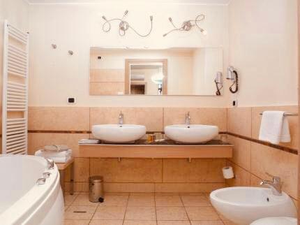a bathroom with two sinks and a mirror at Hotel Europa in Padova