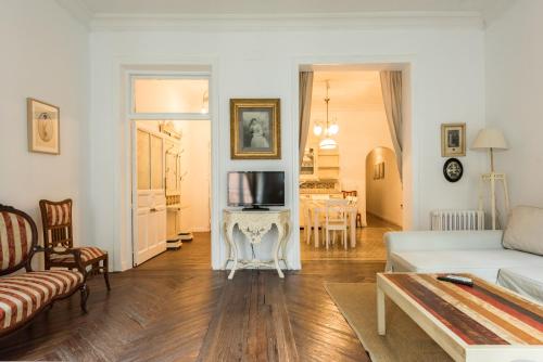 a living room with a couch and a tv at Apartamentos Madrid Centro W in Madrid