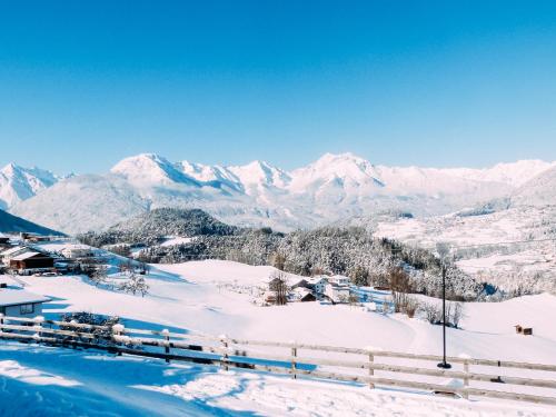 a snow covered mountain with mountains in the background at Pitzis Kinderhotel - Family Only in Arzl im Pitztal