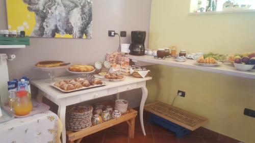 a table with many different types of food on it at B&B La Chora Di Paestum in Paestum