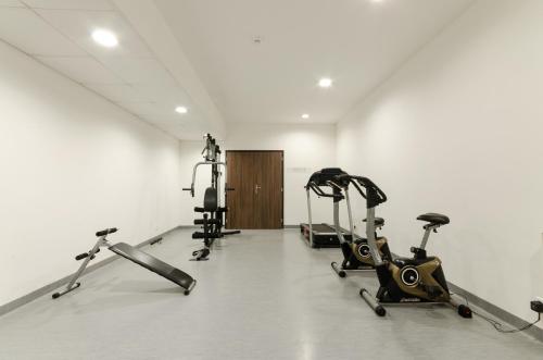 a gym with three exercise bikes in a room at Hotel Kelep in Tokaj