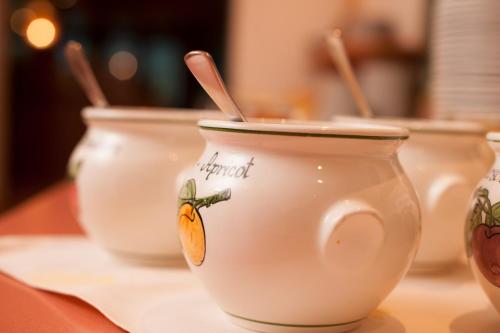 a group of white cups with wooden spoons in them at Hotel Gasteigerhof in Neustift im Stubaital