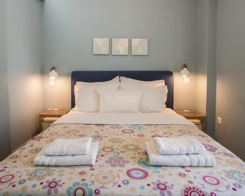 1 dormitorio con 1 cama con 2 almohadas en Piraeus Apartment with Endless View, en Pireo