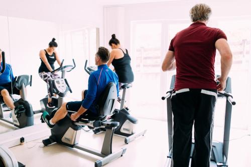 a group of people exercising on exercise bikes in a gym at Pitzis Kinderhotel - Family Only in Arzl im Pitztal