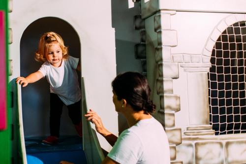 a woman and a little girl standing in a pizza oven at Pitzis Kinderhotel - Family Only in Arzl im Pitztal