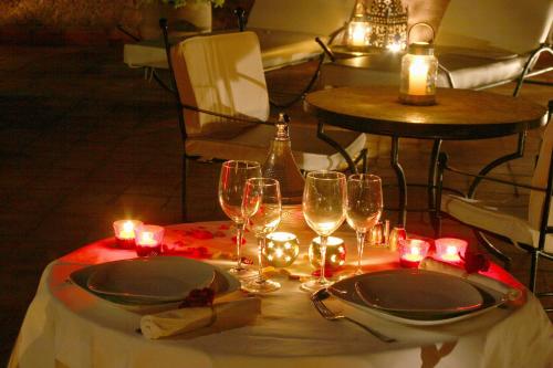 a table with wine glasses and candles on it at Riad Altair in Marrakech