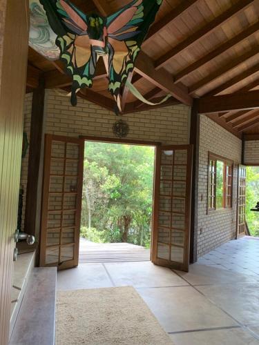 an open door to a house with a ceiling at Pousada Santuário da Madre in Guarda do Embaú