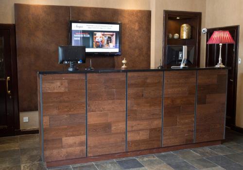 a large wooden entertainment center with a television on top at The Angus Hotel & Spa in Blairgowrie