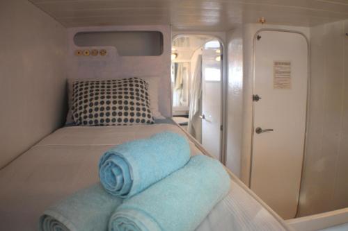 a small bedroom with a bed in an rv at Your own private yacht (17m) on the beach in Barcelona