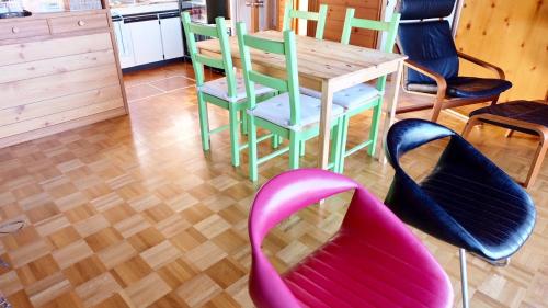 a dining room table with chairs and a wooden table at Smart House Oceanview in Ito