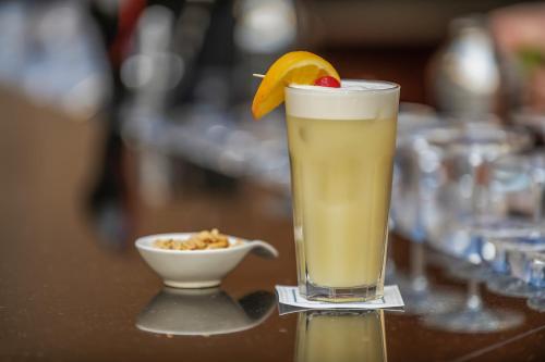 a drink with an orange slice and a bowl of food at Eurostars Danube Budapest in Budapest