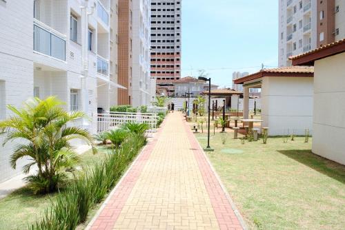 a brick pathway in a city with buildings at Espaço Mahina - Unidade Dez - Apartamento para temporada Praia Grande Ocian in Praia Grande