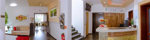 a living room with a hallway with a stairway at Waldhotel Sindelfingen am Eichholz in Sindelfingen