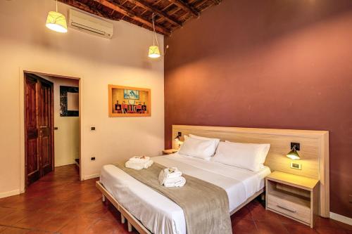 a bedroom with a bed with two towels on it at Guest House o Affittacamere Magenta Fico 2 in Rome