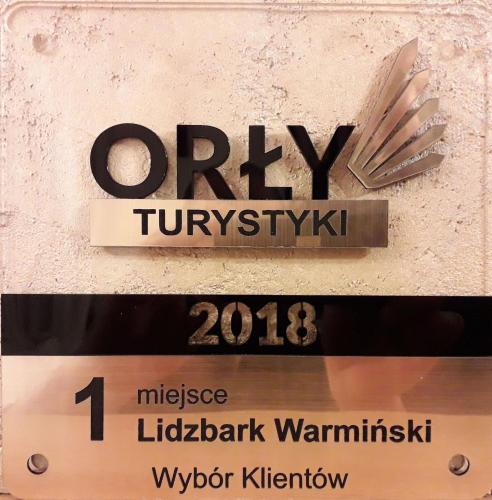 a sign for a car dealership with a sign for a sign at Gospodarstwo Agroturystyczne Rowerowa Przystań "Jankesówka" in Lidzbark Warmiński