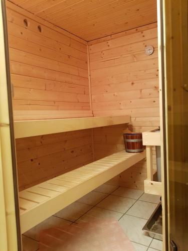a wooden sauna with a bench in it at Susi"s Ferienwohnungen in Wermelskirchen