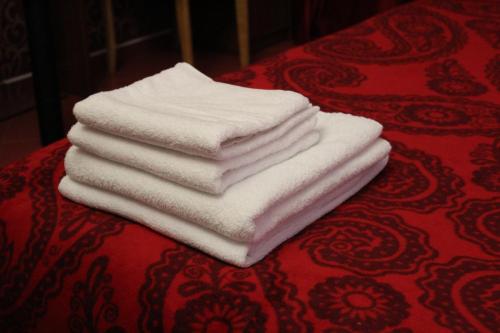 a stack of white towels sitting on a table at Voskhod Hotel in Kyiv