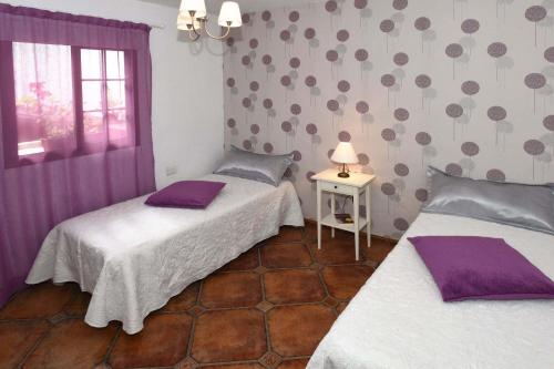 En eller flere senge i et værelse på Casa Acosta