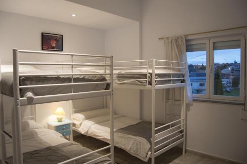 2 Etagenbetten in einem Zimmer mit Fenster in der Unterkunft El Pico de Santillana in Santillana del Mar