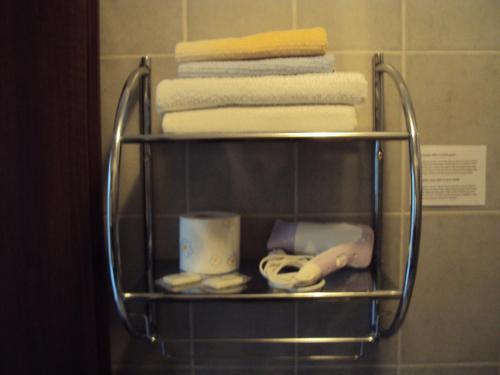 a towel rack in a bathroom with a pile of towels at Villa Kanata in Povile