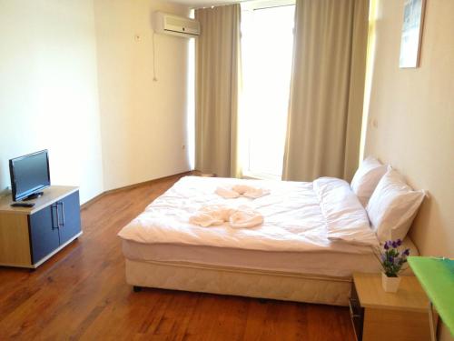 a bedroom with a bed with two towels on it at PSB Apartments in Midia Resort Aheloy in Aheloy