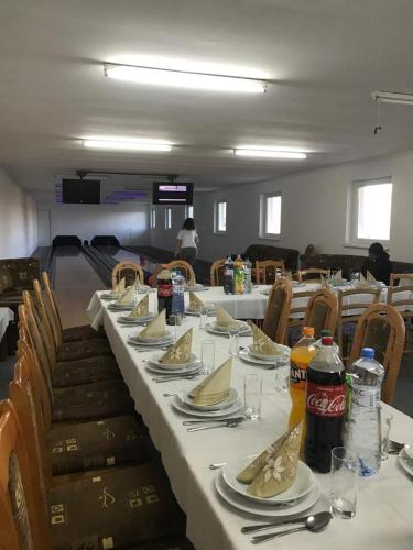 a long table with plates of food on it at PENZION EUROPA Diakovce in Diakovce