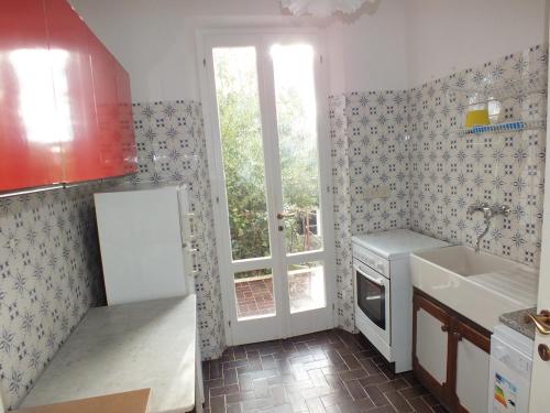 a small kitchen with a sink and a window at Appartamento Montecristo 1 in Marina di Campo