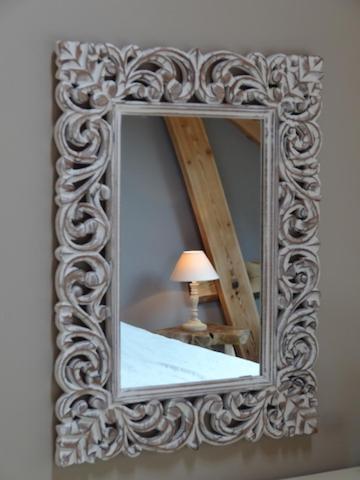 a mirror on a wall with a lamp in it at Maison d'hôtes l'Arnica in La Bréole