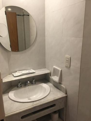 a bathroom with a sink and a mirror at Hotel Rey in Buenos Aires