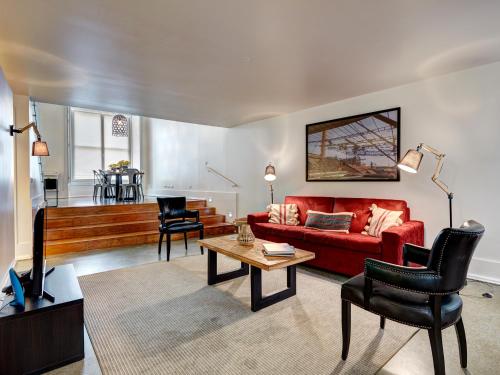a living room with a red couch and a table at Lisbon Canaan Boutique Apartments Gaivotas by Get Your Stay in Lisbon