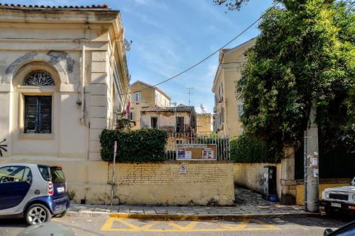 a white car parked in front of a building at Contessina Apt. in Corfu Town