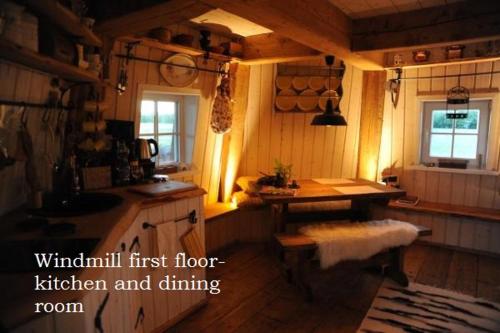 a kitchen with a table and a sink in a room at Windmill - Summer house in Mõega